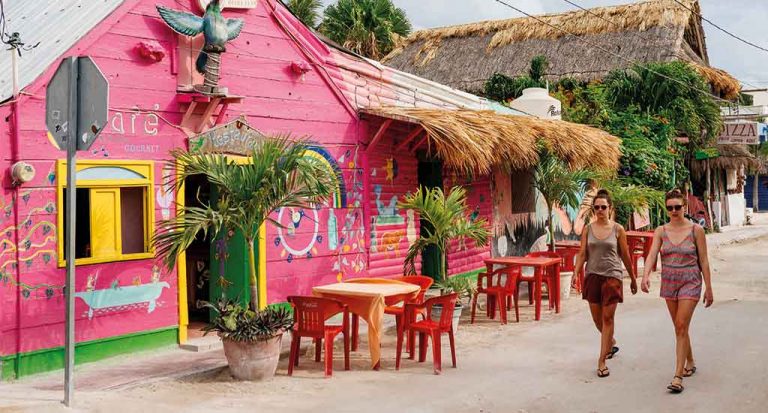 Tourists-walking-past-a-restaurant-in-the-two-of-Isla-Holbox-Mexico-on-Thursday-May-10-2018