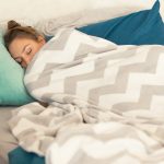 Woman sleeping tucked in a warm blanket